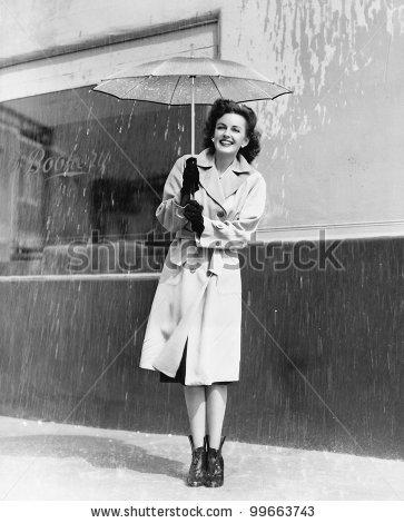 stock-photo-young-woman-in-a-raincoat-and-umbrella-standing-in-the-rain-99663743