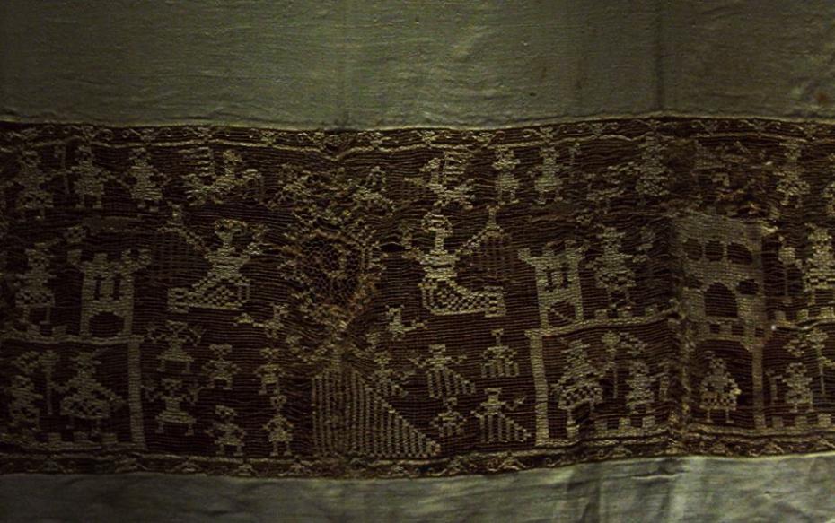 Inside the exhibition -  In the past the religion rites were a good occasion to show refined fabric with original embroideries. Here a baptism veil with a fairy-tale decoration from 17th century.